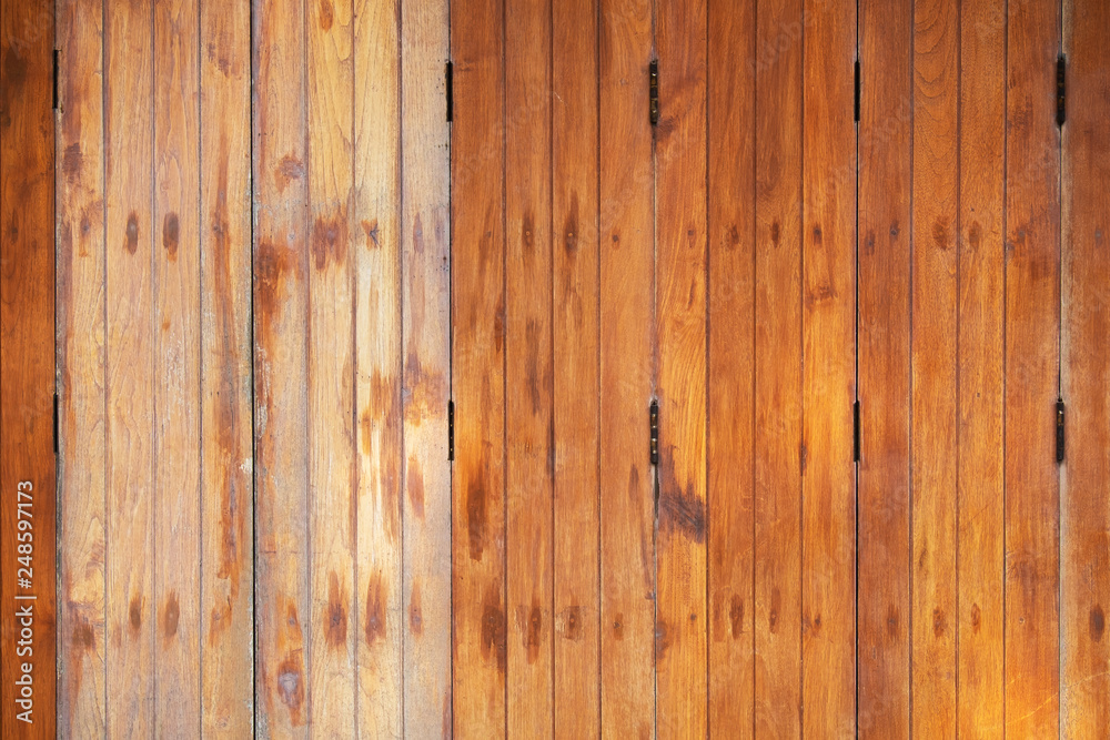 Naklejka premium Vintage Retro Style Fold Simple Wood Doors Texture. Aged Urban House in the Street.