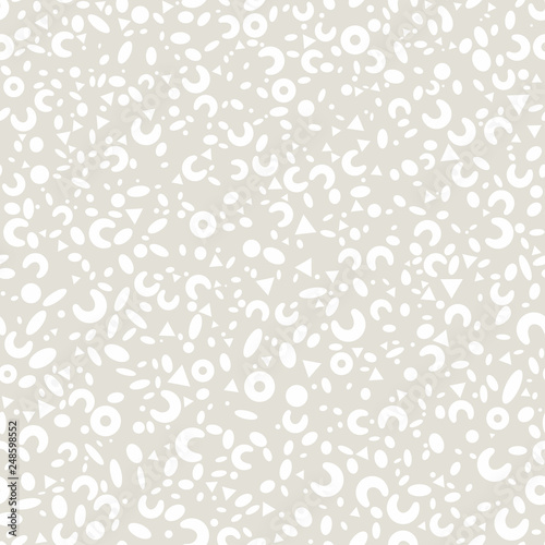 Abstract seamless monochrome pattern from simple white geometric shapes: circles, ovals, triangles, rings on gray background.