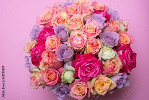 Beautiful bouquet of roses in a gift box. Bouquet of pink roses. Pink roses close-up. on pink background, with space for text.