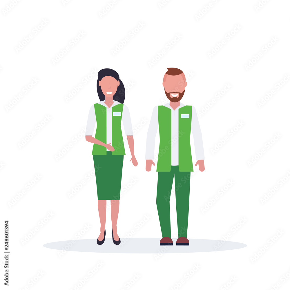 couple man woman supermarket employees standing together salesman and saleswoman in green uniform happy male female cartoon characters full length flat isolated