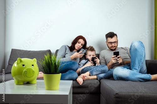 Modern family, everyone is sitting in smartphones than the passionate. The concept of harmfulness of modern gadgets, the detrimental effect on communication, the lack of live communication. photo