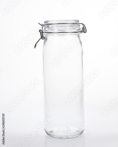 Glass jar with lid on white background