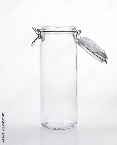 Glass jar with lid on white background