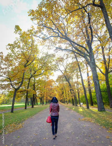 An Asian woman walking at autumn garden