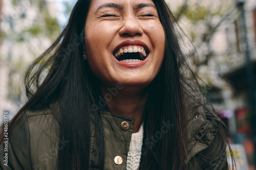 Close up of an asian woman laughing