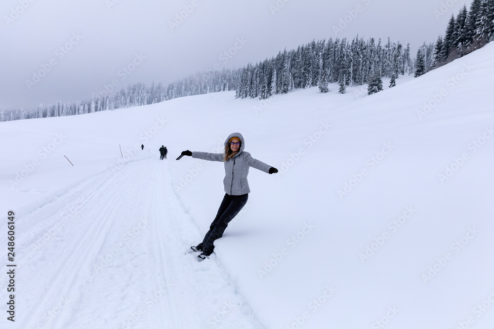 Hapopy tourist lady in her winter holiday in the mountains