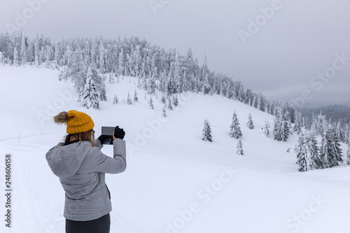 Hapopy tourist lady in her winter holiday in the mountains