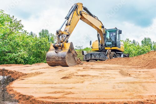 Excavator aligns surface of sand