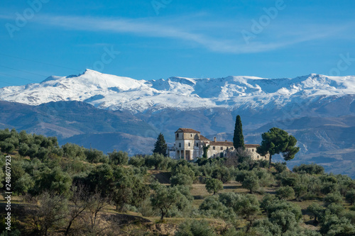 View from the city of Granada to mountain Sierra Nevada and a abandoned old house