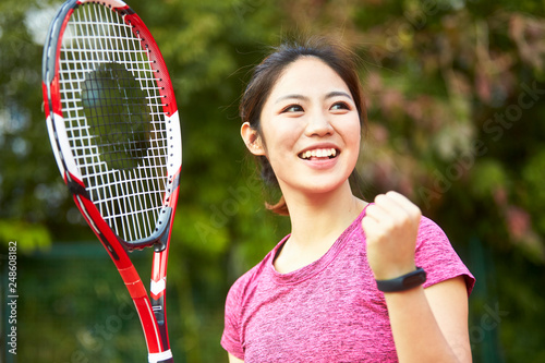 portrait of happy asian female tennis player © imtmphoto