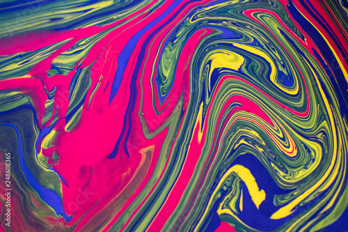 Abstract background with psychedelic vivid colors. Marbleized bright effect with fluid painting, background for wallpapers, poster, postcard. Swirls and lines with yellow, blue, purple and magenta.