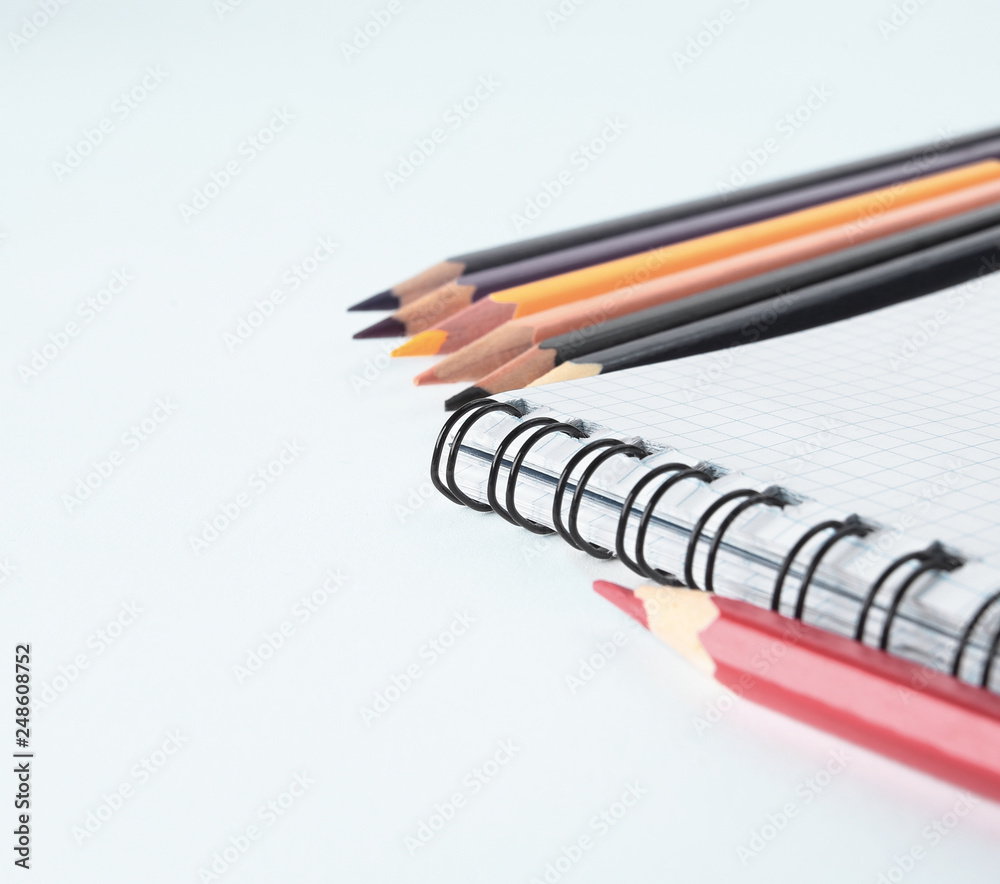 close up.Notepad and pencils on white background .photo with copy space.background close up.Notepad and pencils on white background .photo with copy space.background