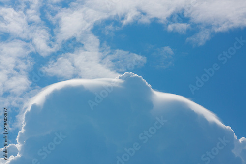 fluffy white cloud above clear blue sky