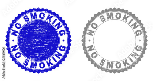 Grunge NO SMOKING stamp seals isolated on a white background. Rosette seals with grunge texture in blue and gray colors. Vector rubber stamp imprint of NO SMOKING label inside round rosette.