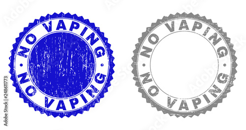 Grunge NO VAPING stamp seals isolated on a white background. Rosette seals with grunge texture in blue and gray colors. Vector rubber stamp imitation of NO VAPING text inside round rosette.