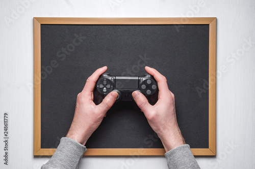 Hand hold new joystick isolated. Gamer play game with gamepad controller. Gaming man holding simulator joypad. Person with keypad joystic in arms. Sleeve hands hold toy equipment. Modern manipulator. photo