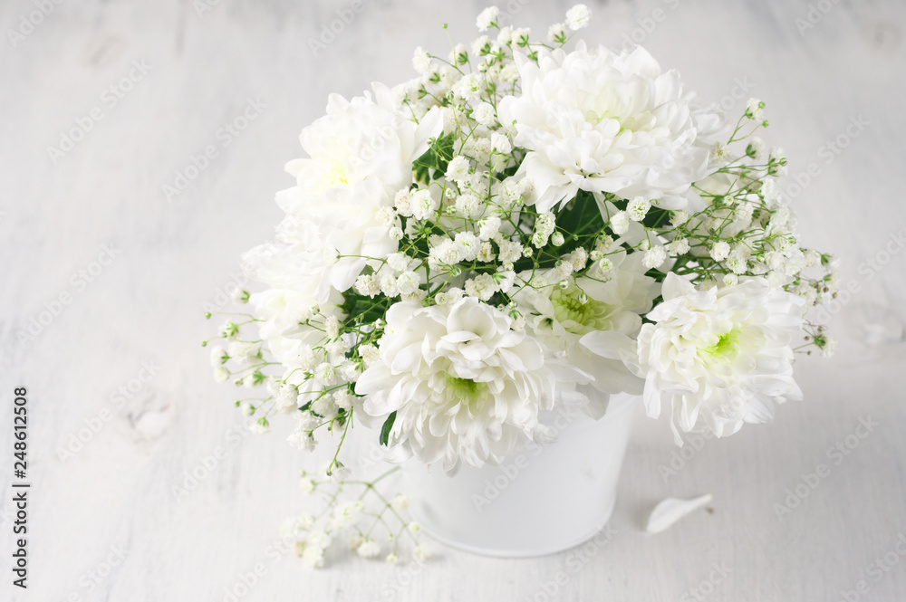 White flowers bouquet in bucket