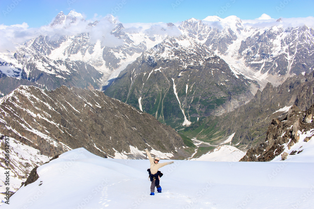 The girl enjoys the view from the past to the mountains. View of Ushba and Elbrus mountains