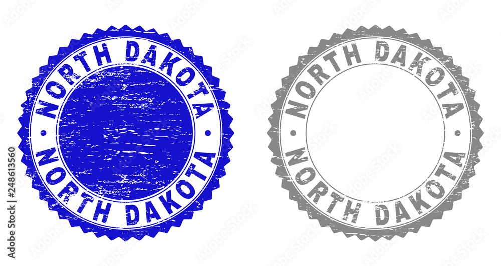 Obraz premium Grunge NORTH DAKOTA stamp seals isolated on a white background. Rosette seals with grunge texture in blue and gray colors. Vector rubber overlay of NORTH DAKOTA caption inside round rosette.