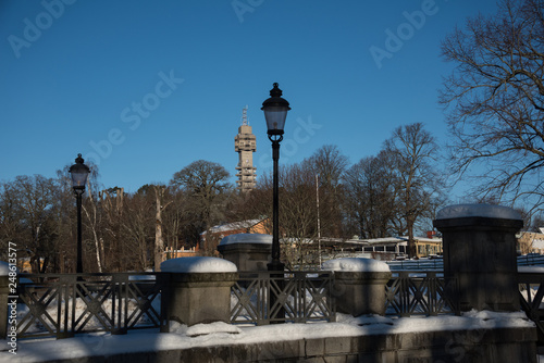 Snowy winter view at the Djurgården island, the teletower Kaknäs photo