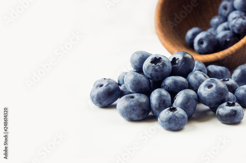 Sprinkled blueberries on white background. Ripe blueberries with copy space for text. Blueberry on a white background.