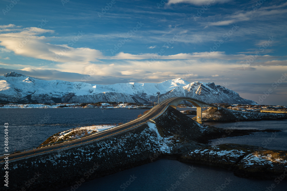 Fototapeta premium Atlantic Ocean Road in winter sunny day. Famous high bridge over the sea.