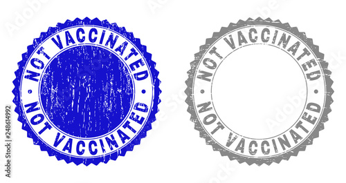Grunge NOT VACCINATED stamp seals isolated on a white background. Rosette seals with grunge texture in blue and gray colors. Vector rubber stamp imitation of NOT VACCINATED title inside round rosette.