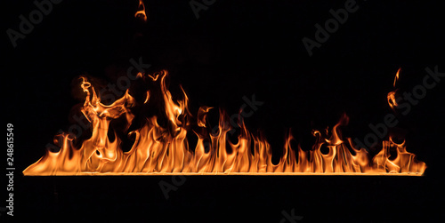 Texture of fire wall isolated on a black background.