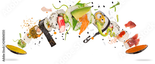 Pieces of delicious japanese sushi frozen in the air. Isolated on white background