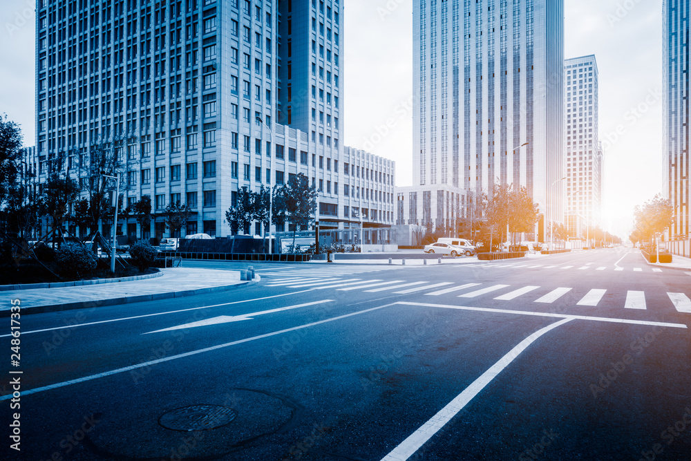 Fototapeta premium city empty traffic road with cityscape in background.