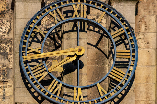 Old clock on medieval church close up shoot.