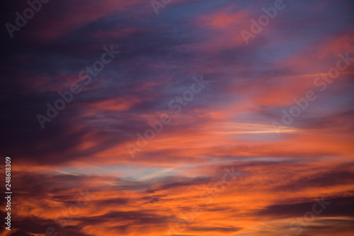  Sunset sky with clouds. Golden sunlight  for your idea of web header. Cloudy landscape for background in serenity colors - blue  violet  yellow and pink tone.