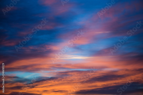  Sunset sky with clouds. Golden sunlight  for your idea of web header. Cloudy landscape for background in serenity colors - blue, violet, yellow and pink tone. © dmytro_khlystun
