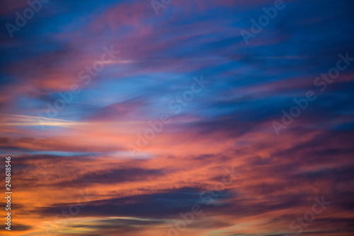  Sunset sky with clouds. Golden sunlight  for your idea of web header. Cloudy landscape for background in serenity colors - blue, violet, yellow and pink tone. © dmytro_khlystun