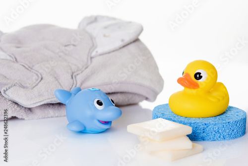 Still life with baby hygiene and bath items, baby soap, towel,  rubber toy, shower puff