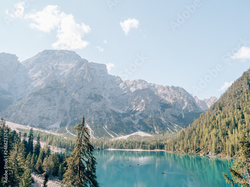 Lago di Braies in the Dolomites in the italian Alps on a sunny day with many tourists on the lake