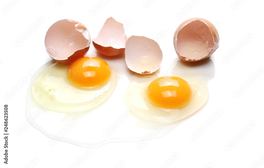 Cracked eggs, eggshells with yolk isolated on white background Cracked eggs, eggshells with yolk isolated on white background