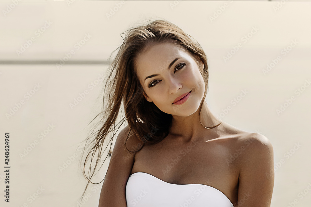 Beautiful cheerful smiling happy woman on the sea in the sunset. Beautiful cheerful smiling happy woman on the sea in the sunset.