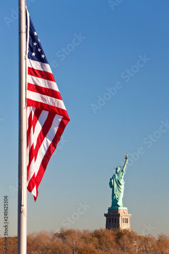 Statue of Liberty, Stars and Stripes Flag, New York City © Darren Baker