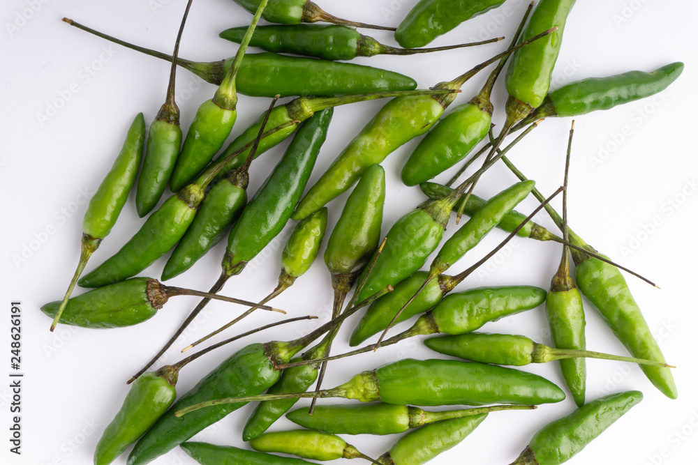Fototapeta premium Green Bird's eye chili ,Thai Chili pepper ,bird chili pepper nature isolate on white background. Selective focus and crop fragment