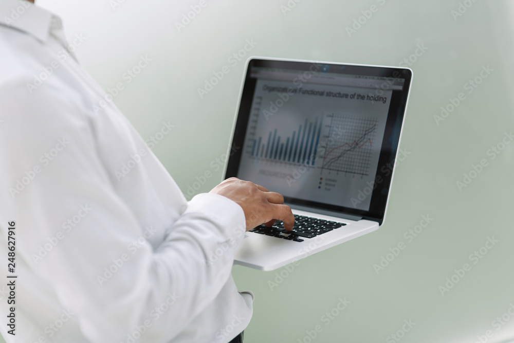 close up. a businessman uses a laptop to work with financial data. close up. a businessman uses a laptop to work with financial data.