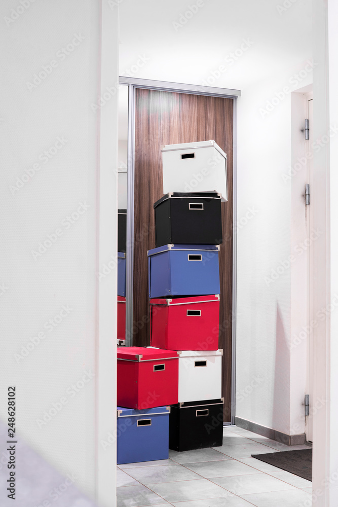 Stacked boxes in various colors in a bright room Stacked boxes in various colors in a bright room