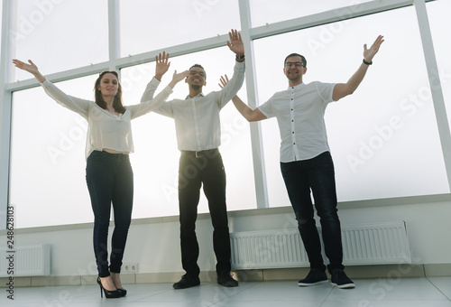 young business team standing in a bright office