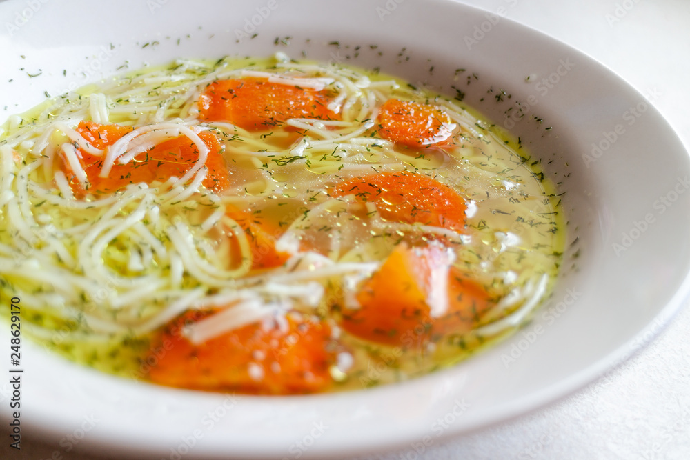 Chicken broth with carrot and dill. Traditional polish soup. Chicken broth with carrot and dill. Traditional polish soup.