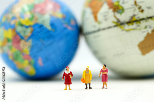 Miniature people : Group of Women Teamwork Happiness with world map using for concept of International women day.