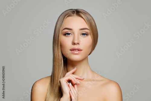 Perfect young woman. Pretty girl with healthy blonde hair and clear skin portrait. Facial treatment, cosmetology, hair and skin care concept photo