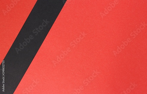 Red paper with black simple stripe decor in left side corner, empty copy space background