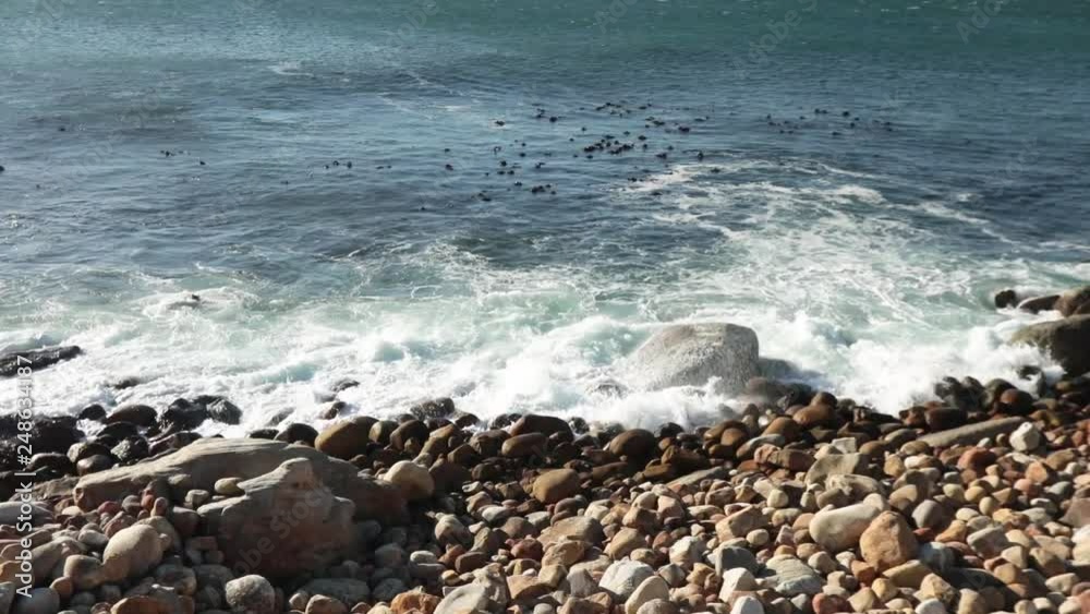 Waves crashing on a pebble beach, near Camp's Bay, Cape Town