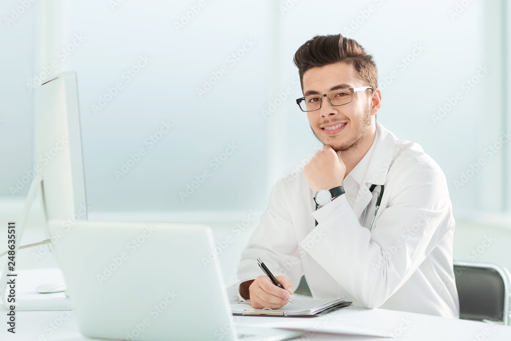 doctor therapist sitting at a table in his office doctor therapist sitting at a table in his office