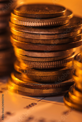 selective focus of coins stack on blurred document and background